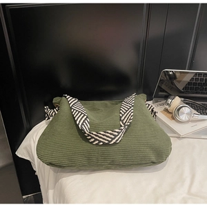 Détail du cabas en velours côtelé vert armée avec bandoulière tissée noir et blanc