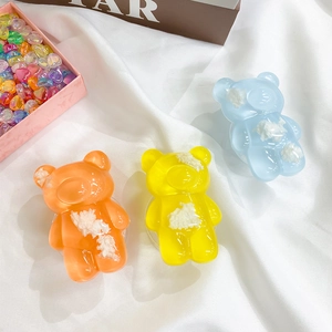 Close-up of cute transparent bear phone sockets in orange, yellow, and blue colors