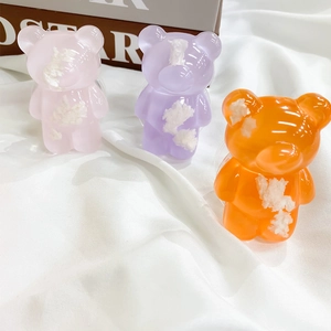 Detailed view of semi-transparent bear phone grips in pink, purple and orange colors