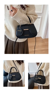 Close-up of black PU leather saddle bag with gold metal bar and fashion tag detail