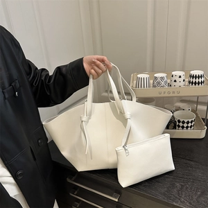 White lychee pattern leather tote bag with small zipper pouch in minimalist wing design