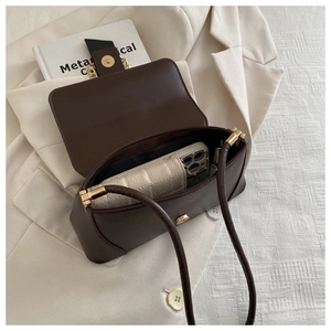 Detail showing the internal capacity of the dark brown leather baguette shoulder bag