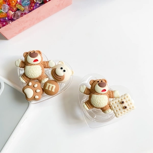 Detail view of 3D cartoon bear and cookie charms on heart-shaped phone grip base
