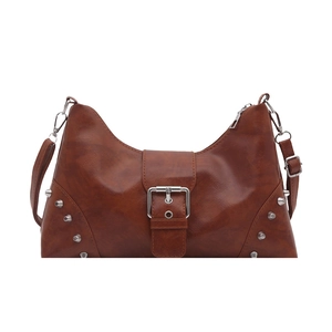 Retro brown rivet tote bag with silver buckle and punk style shoulder strap on white backdrop
