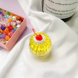 Detailed shot of yellow jelly cake resin phone grip with red cherry and white cream topping