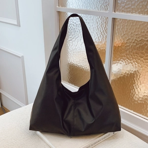 Minimalist black oversized hobo bag in soft leather texture for women's daily commute