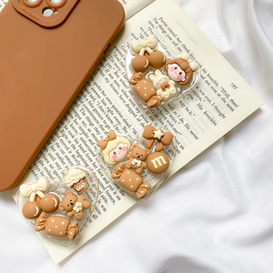 Detail of heart-shaped acrylic phone grips with cartoon bear and candy resin charms