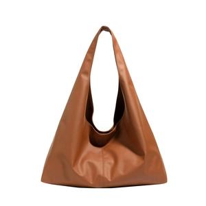 Minimalist caramel brown leather tote bag with wide shoulder strap in a spacious hobo design