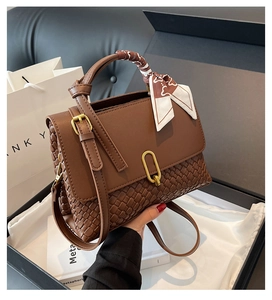 Brown woven crossbody bag with silk scarf handle and golden U-shaped buckle detail