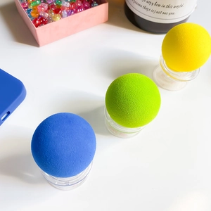 Detailed view of colorful spherical phone grips in blue green and yellow matte finish