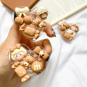 Macro shot of heart-shaped acrylic phone grip with cute bear and chocolate bean decors