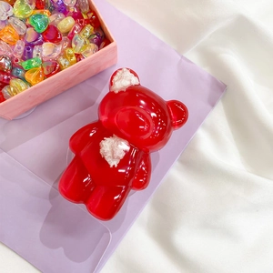 Detail view of cute red bear phone socket with plush ears and heart bead decor