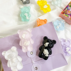 Close-up of cute 3D bear phone grips in various transparent candy colors and glossy resin