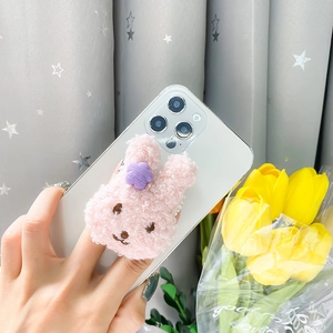 Cute pink plush rabbit phone socket stand with purple flower decoration on white smartphone