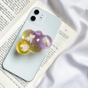 Detail of yellow and purple gradient cloud phone grip with glitter and 3D texture