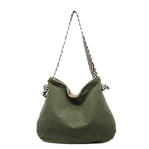 Green corduroy tote bag with black and white striped strap for casual daily use