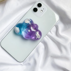 Detail of glitter cloud phone grip featuring blue-purple resin gradient and tiny sparkles