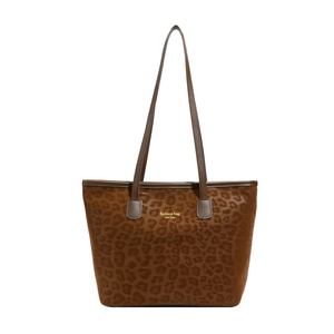 Leopard print tote bag with brown leather handles and golden New York text branding