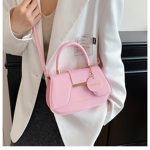 Detail of pink PU leather saddle bag with fashion metal chain and logo engraving
