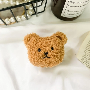 Close-up of cute brown teddy plush bear accessory on a minimalist aesthetic background