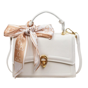 White faux leather top handle bag with gold oval lock and decorative silk scarf detail