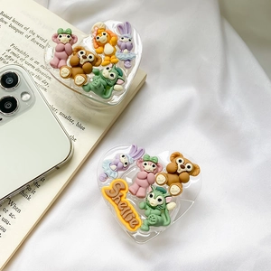 Detail view of acrylic heart phone grips featuring 3D cartoon characters on white fabric