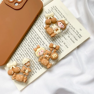 Cute brown bear and rabbit heart-shaped phone grip stands on vintage book background