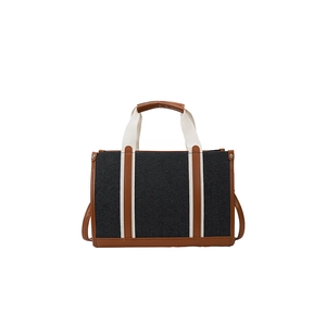 Blue canvas tote bag with brown leather trim and white handles for commuting