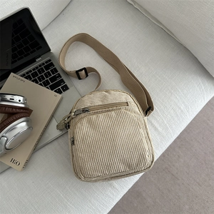 Minimalist beige corduroy crossbody bag with adjustable strap and vintage casual style