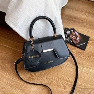 Minimalist black PU leather saddle bag with gold metal buckle and round fashion charm