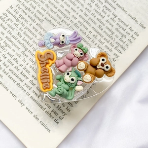 Close-up of heart-shaped phone grip with 3D cartoon rabbits and bears characters