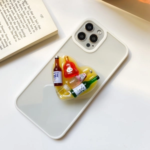 Detailed view of creative beer bottle resin heart phone grip on a beige mobile case
