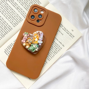 Caramel silicone phone case with heart-shaped 3D capsule featuring cartoon characters