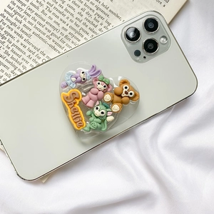 Heart-shaped foldable phone grip with cartoon Duffy characters on a light teal phone
