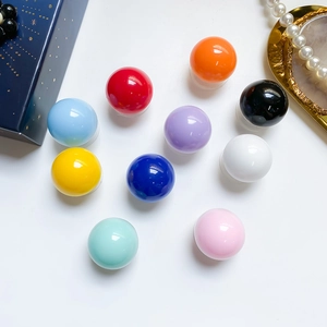 Macro shot of 10 colorful crystal phone grip holders with glossy finish on a white base