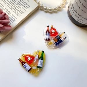 Macro detail of heart-shaped resin phone socket with miniature beer bottles inside