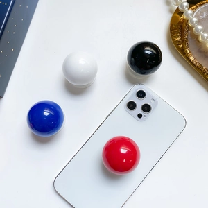 Macro detail of glossy spherical cell phone socket grips in red, blue, and black finishes
