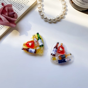 Macro detail of heart-shaped resin phone socket with miniature beer bottle charms inside