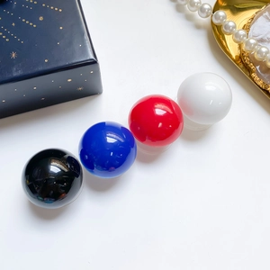 Close-up of colorful crystal ball phone sockets in glossy red, blue, white, and black