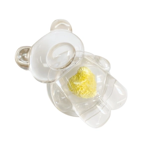 Transparent bear phone grip with yellow heart inlay on a clean white background