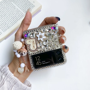 Detail of luxury rhinestone phone case for Samsung Z Flip with 3D flower and Eiffel tower charm