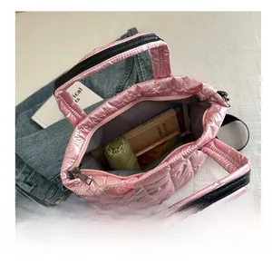 Interior view of pink quilted tote bag showing large capacity for books and umbrella