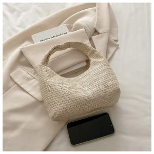 Detail shot of the woven herringbone pattern on a beige hobo bag with a smartphone for scale