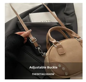 Close-up of adjustable silver buckle and suede texture on vintage bowling bag