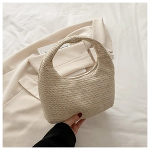 Detail of woven crescent hobo bag in cream white showing intricate textured pattern