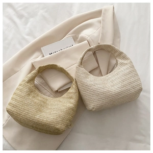 Flat lay of woven hobo bags in cream and tan colors on a stylish blazer garment