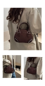 Macro detail of dark brown textured mini satchel with silver rivets and metal hardware