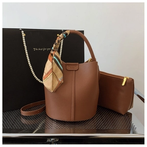 Detail of brown litchi pattern leather bucket bag with inner pouch and silk scarf