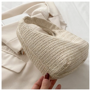 Detailed view of beige woven handbag texture and premium straw material craftsmanship