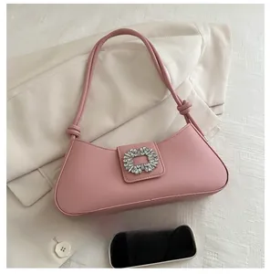 Pink baguette shoulder bag featuring a crystal square buckle and knotted strap detail